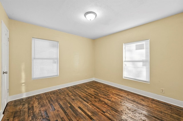 spare room featuring dark hardwood / wood-style flooring