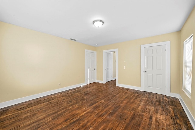 unfurnished bedroom featuring dark hardwood / wood-style flooring