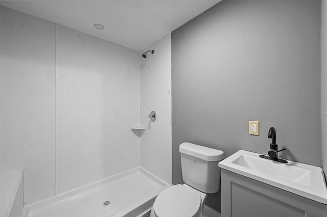 bathroom with vanity, a shower, and toilet