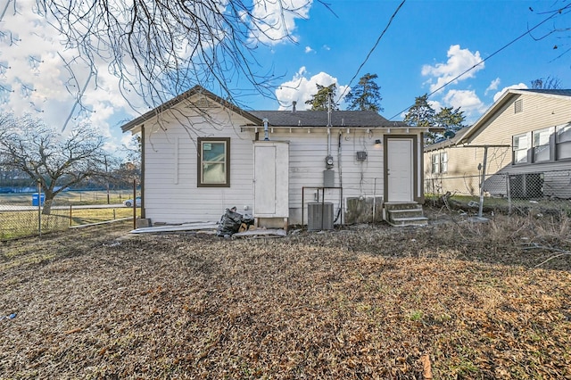 rear view of property with central AC