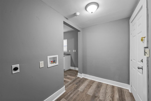 washroom featuring dark wood-type flooring, washer hookup, and hookup for an electric dryer