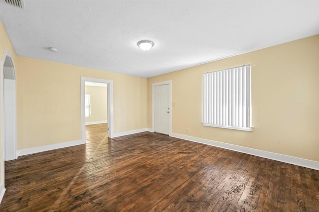 spare room with dark wood-type flooring