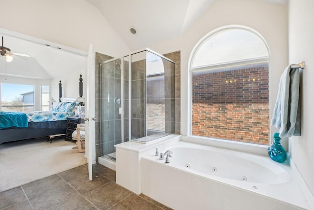 bathroom with ceiling fan, vaulted ceiling, and separate shower and tub