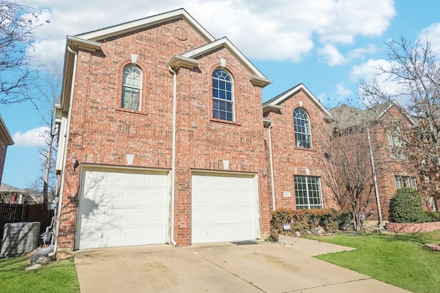 view of property with a garage and a front yard