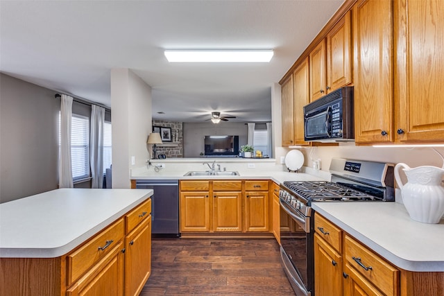 kitchen featuring stainless steel gas range, sink, dark hardwood / wood-style flooring, kitchen peninsula, and dishwasher