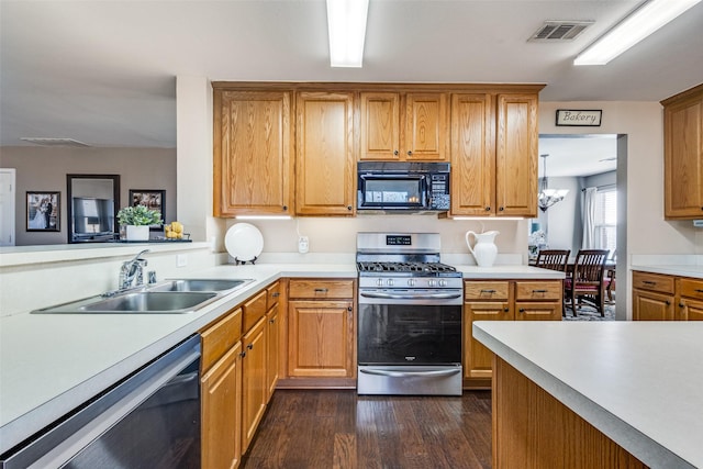 kitchen featuring sink, stainless steel gas range oven, dark hardwood / wood-style flooring, dishwashing machine, and a notable chandelier