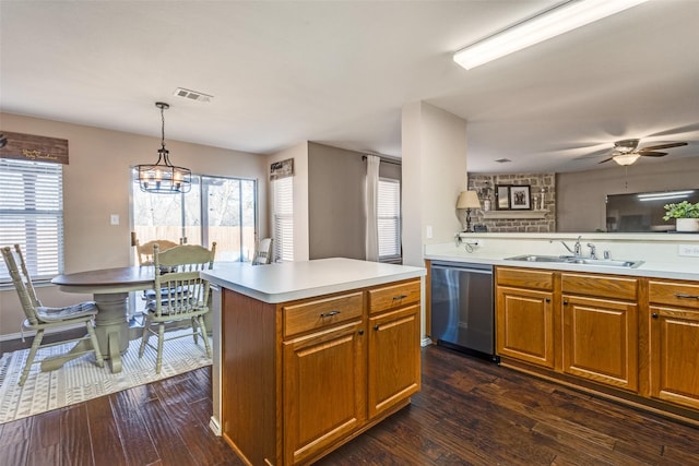 kitchen with sink, a center island, dark hardwood / wood-style flooring, dishwasher, and pendant lighting