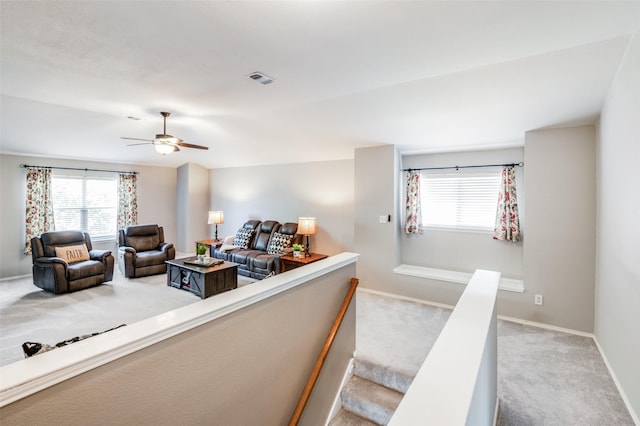 living room with light carpet and ceiling fan