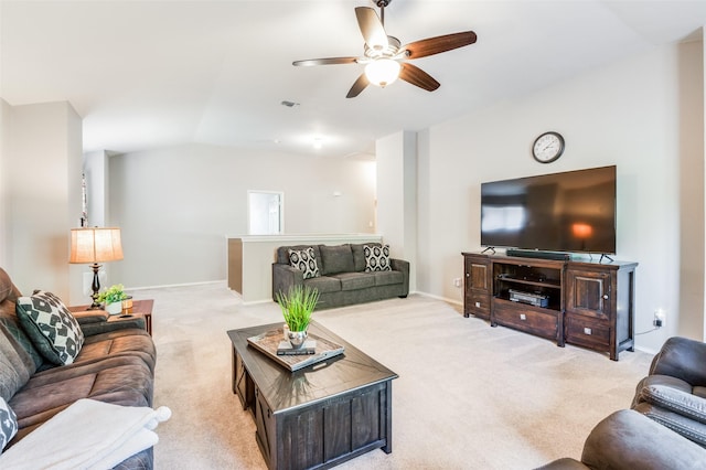 carpeted living room with vaulted ceiling and ceiling fan