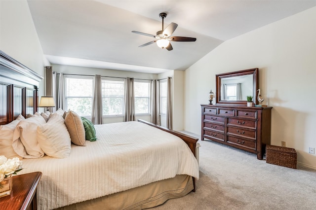 bedroom featuring lofted ceiling, light carpet, and ceiling fan