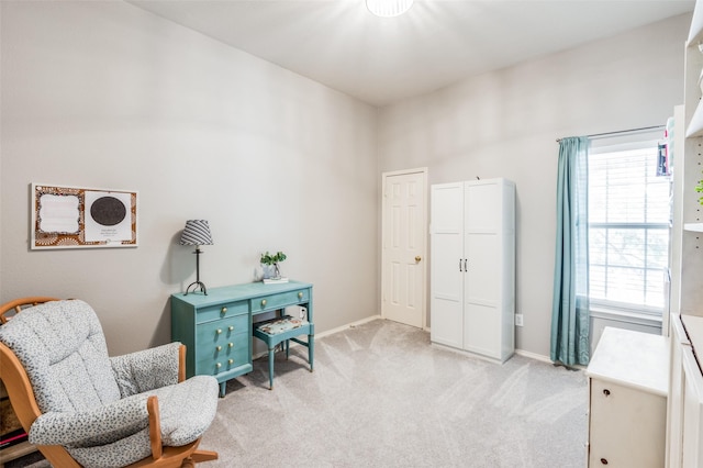 living area with a wealth of natural light and light colored carpet