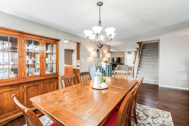 dining area featuring dark hardwood / wood-style flooring and a chandelier