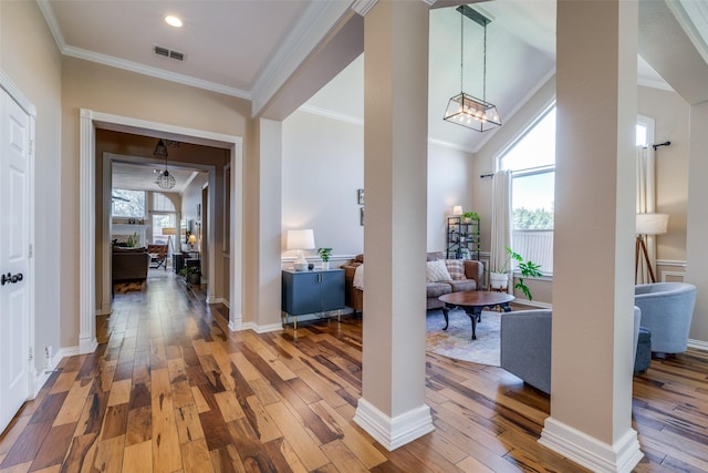 interior space with ornamental molding, hardwood / wood-style floors, and a wealth of natural light