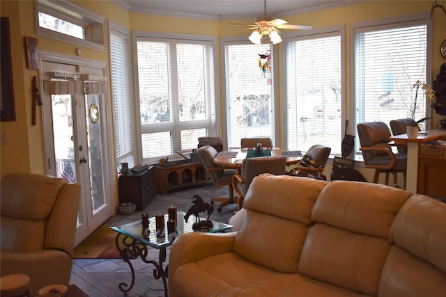 living area with french doors, crown molding, and ceiling fan