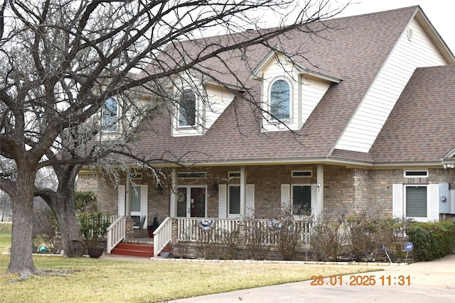 view of front of house with a porch and a front yard