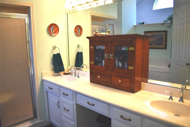 full bathroom with double vanity, a sink, and a shower stall