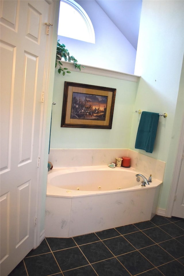 full bathroom with lofted ceiling, a tub with jets, and tile patterned flooring