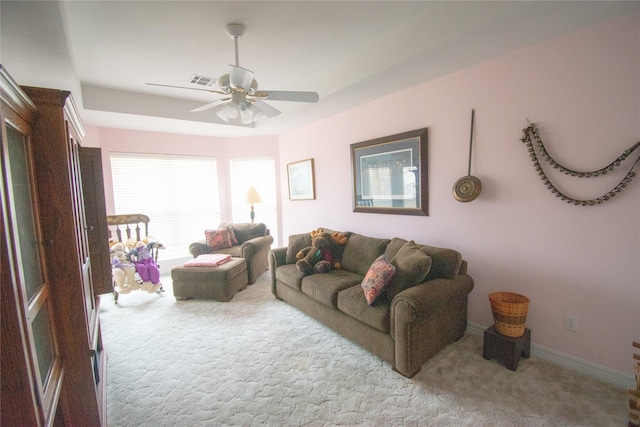 living room with carpet floors, visible vents, ceiling fan, and baseboards