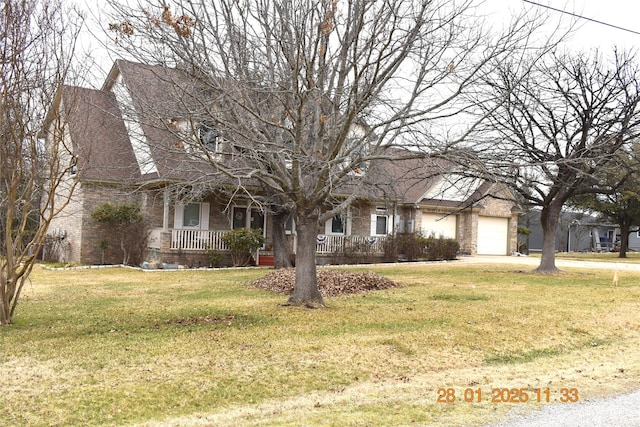 view of front of property with a garage, covered porch, and a front lawn