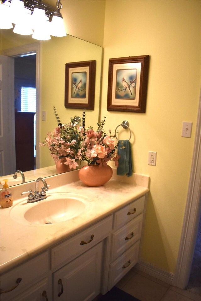 bathroom featuring tile patterned flooring, vanity, and baseboards