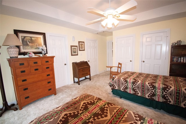 bedroom featuring light carpet and a ceiling fan