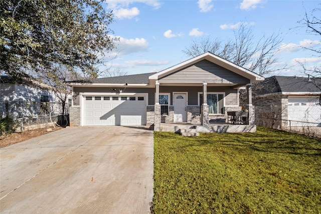 view of front of property with a garage, a front yard, and covered porch