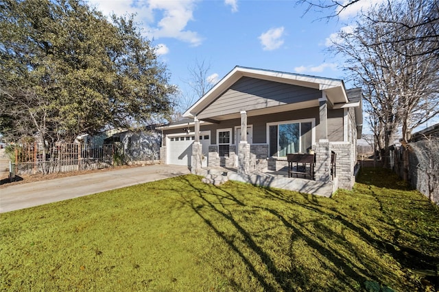 view of front facade featuring a garage, covered porch, and a front yard