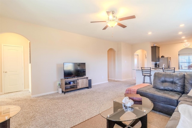 carpeted living room featuring ceiling fan