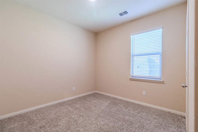 spare room featuring a healthy amount of sunlight and carpet flooring