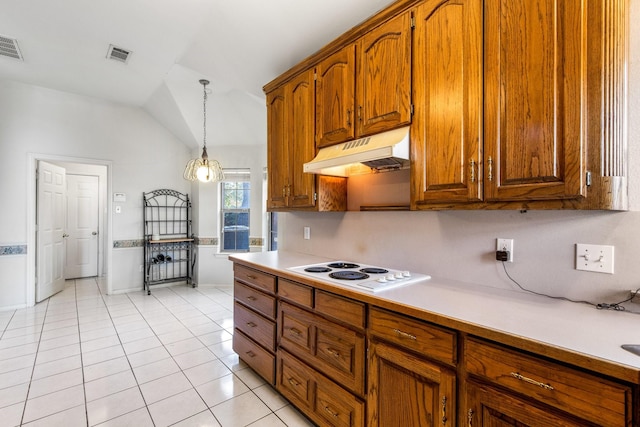 kitchen with lofted ceiling, light tile patterned floors, white electric stovetop, pendant lighting, and exhaust hood