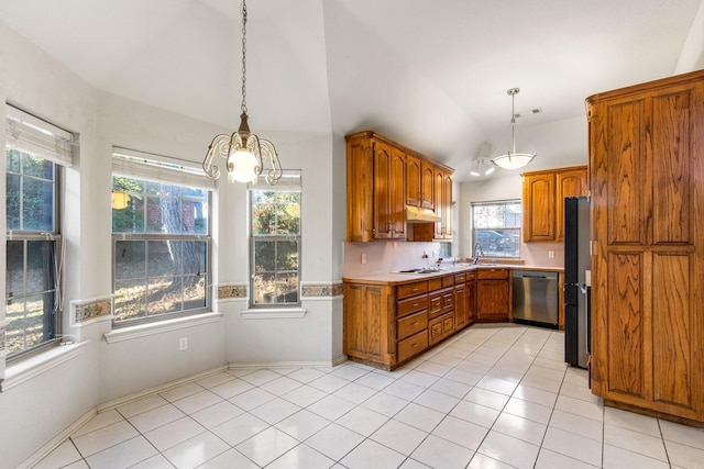 kitchen with vaulted ceiling, appliances with stainless steel finishes, decorative light fixtures, sink, and light tile patterned floors