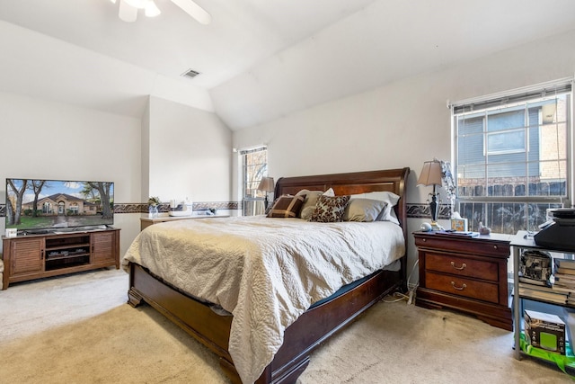 bedroom featuring vaulted ceiling, light carpet, and ceiling fan