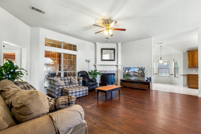 living room featuring ceiling fan, a fireplace, and light hardwood / wood-style floors