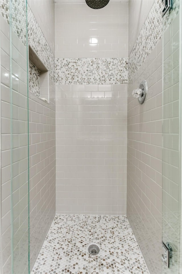 bathroom with a tile shower