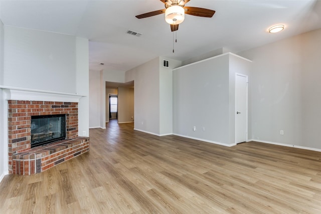 unfurnished living room with a fireplace, light hardwood / wood-style flooring, and ceiling fan