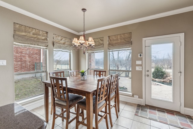 dining space featuring a notable chandelier, ornamental molding, and light tile patterned flooring