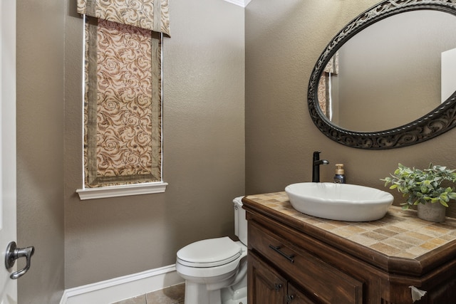 bathroom featuring vanity, toilet, and tile patterned flooring