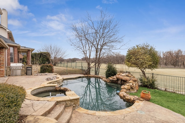 view of pool featuring an in ground hot tub, area for grilling, exterior kitchen, and a patio area