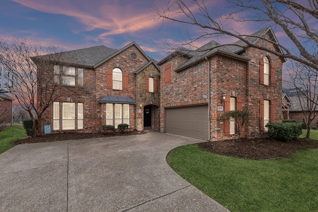 view of front of property with a garage and a lawn