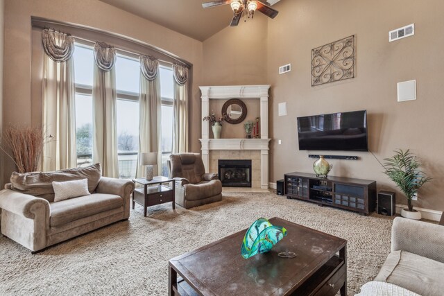 living room featuring ceiling fan, a fireplace, and carpet