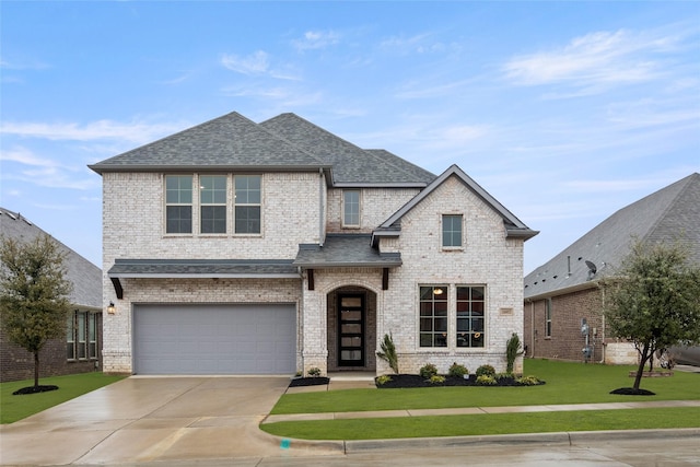 view of front of home with a garage and a front lawn