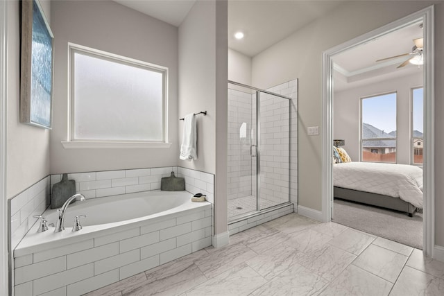 bathroom featuring ceiling fan and independent shower and bath