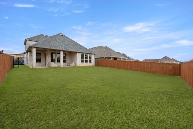 rear view of property with a lawn