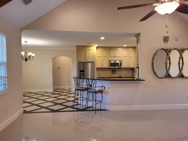 kitchen with a kitchen bar, tasteful backsplash, crown molding, appliances with stainless steel finishes, and kitchen peninsula