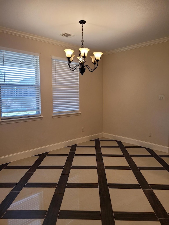 spare room with ornamental molding and a chandelier