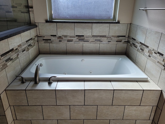 bathroom with a relaxing tiled tub