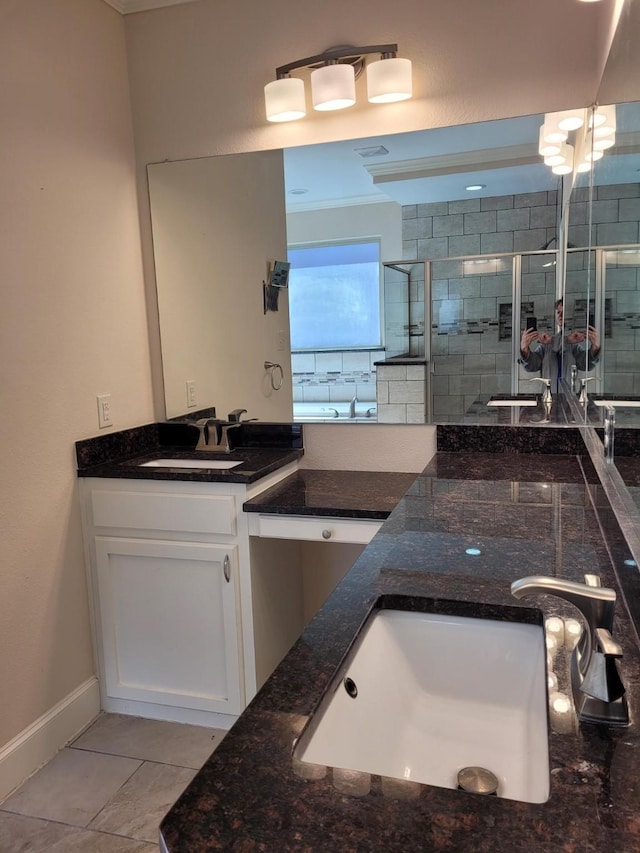 bathroom with vanity, an enclosed shower, and tile patterned flooring