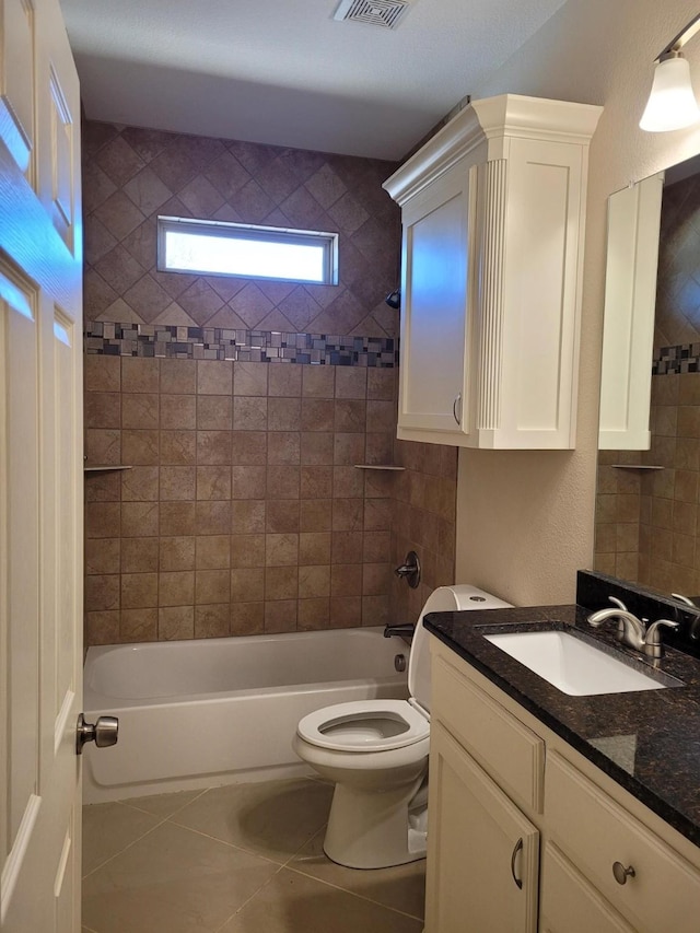 full bathroom with vanity, toilet, tile patterned floors, and tiled shower / bath