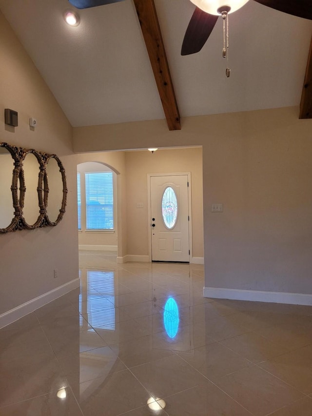 tiled foyer featuring beamed ceiling, ceiling fan, and high vaulted ceiling