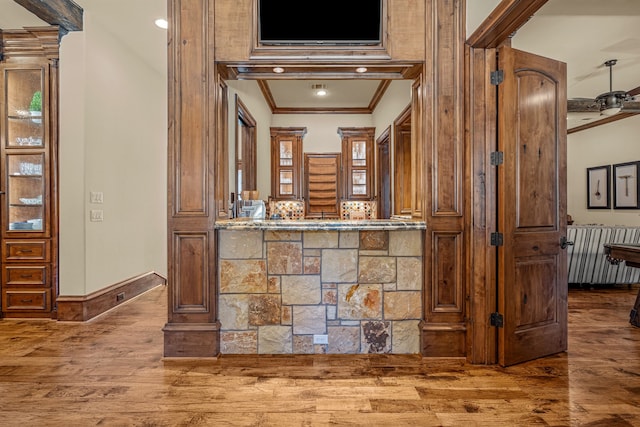 bar featuring wood-type flooring and ornamental molding